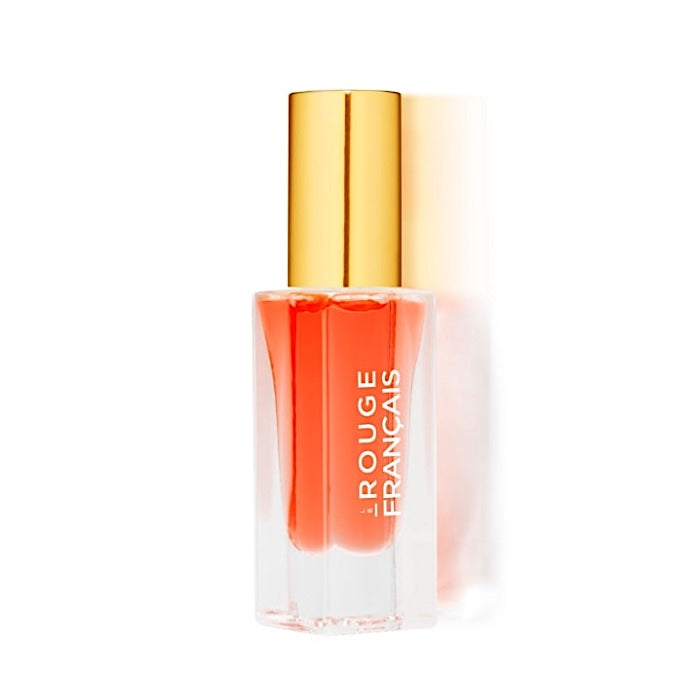 Lippenöl Glasflasche von Le Rouge Francais Orange Persephone steht vor weißem Hintergrund.