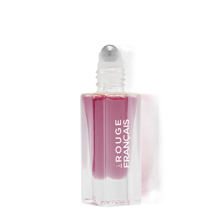 Offene Le Rouge Francais Le Nectar Lippenöl Glasflasche mit Applikatorkugel vor weißem Hintergrund.