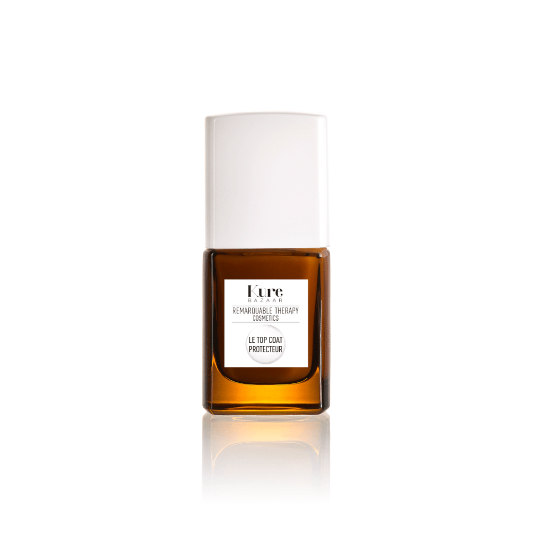 Le Topcoat Protecteur Nagellackflasche steht vor weißem Hintergrund. North Glow
