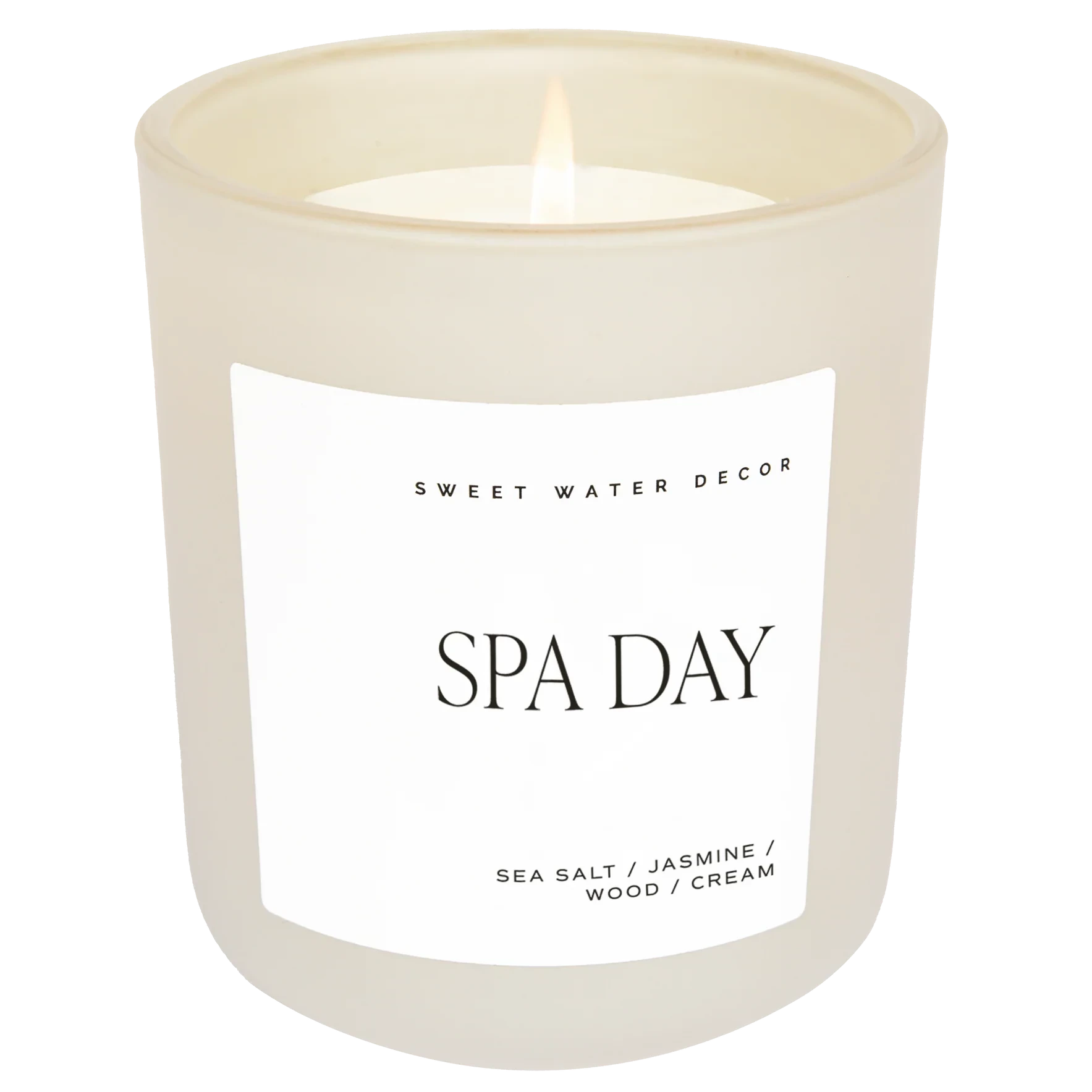 Cremefarbenes Kerzenglas mit der Aufschrift "Spa Day", vor weißem Hintergrund
