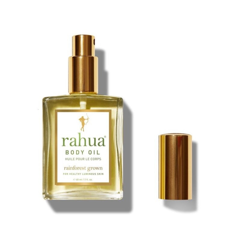 Offene Flasche Rahua Body Oil, Deckel daneben, vor weißem Hintergrund.