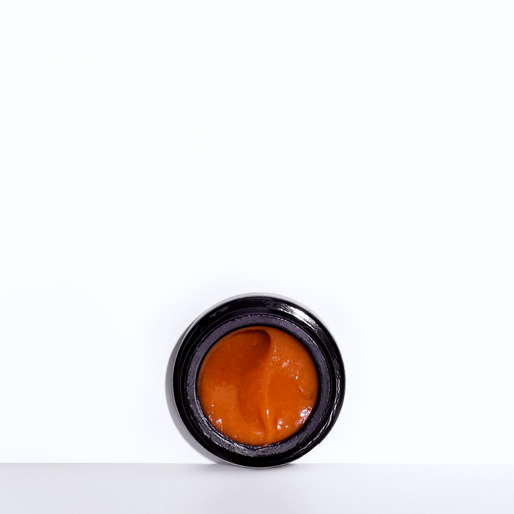 Lilfox JungleGlow black jar with orange consistency against white background