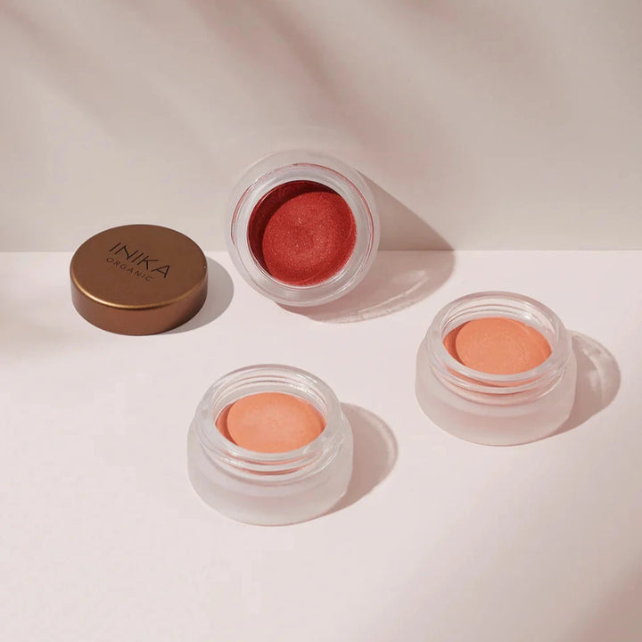 3 Lip & Cheek Creams geöffnet, ein Deckel ligened daneben.