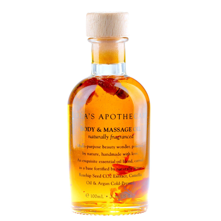 Glasflasche Lola´s Apothecary Body & Massageöl mit orangerotem Inhalt.