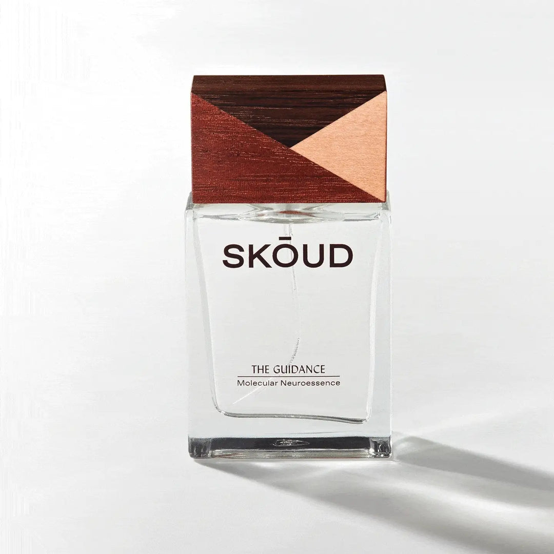 Parfum Glasfalkon von Skoud The Guidance mit Design-Holzdeckel vor hellem Hintergrund.