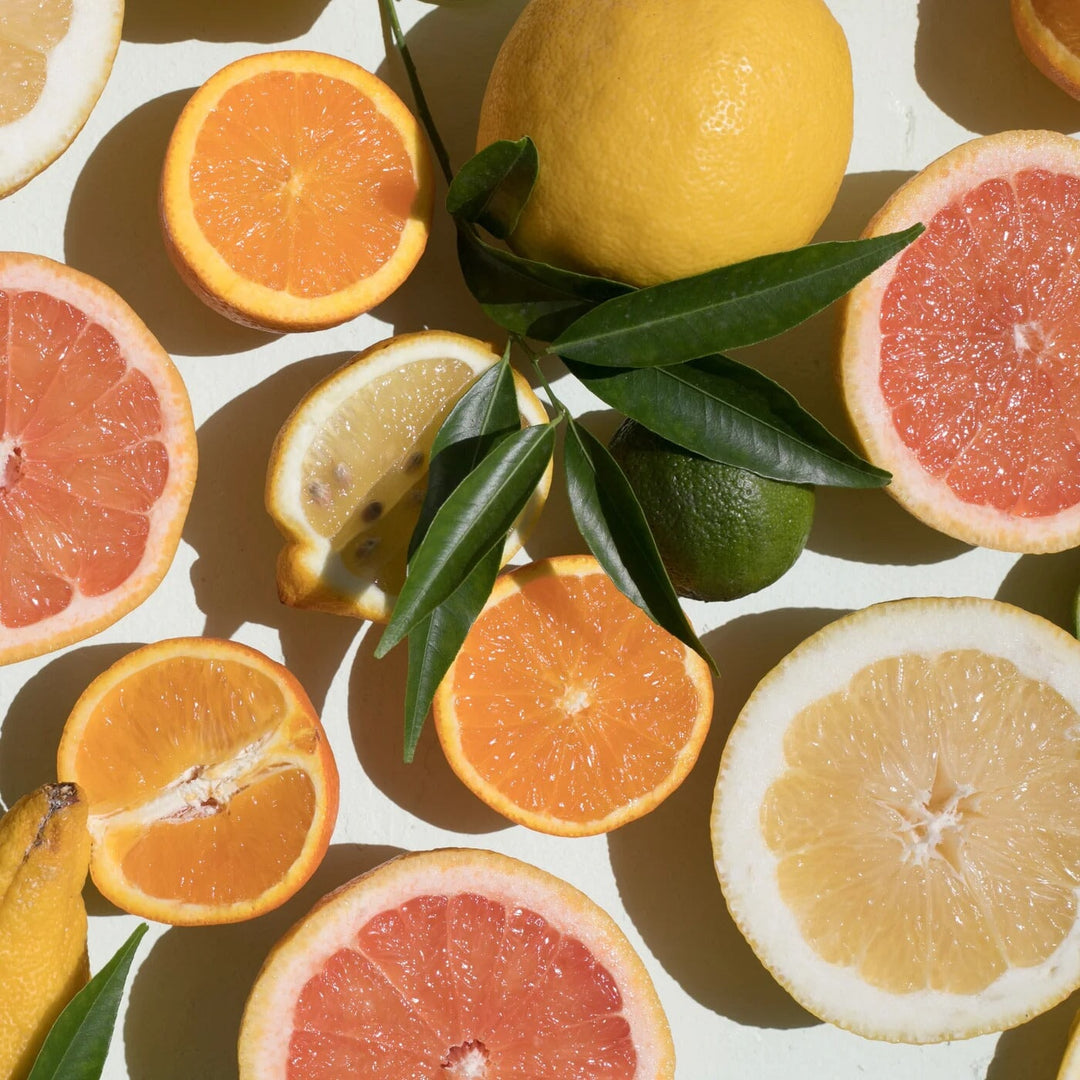 Aufgeschnittene Zirusfrüchte wie Orange, Mandarine, Blutorange und Limette liege auf weißem Untergrund aus der Vogelperspektive sichtbar.  North Glow