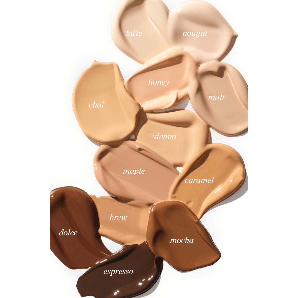 Verschiedene Farben der Ere Perez Oat Milk Foundation mit Beschriftung auf weißem Untergrund.