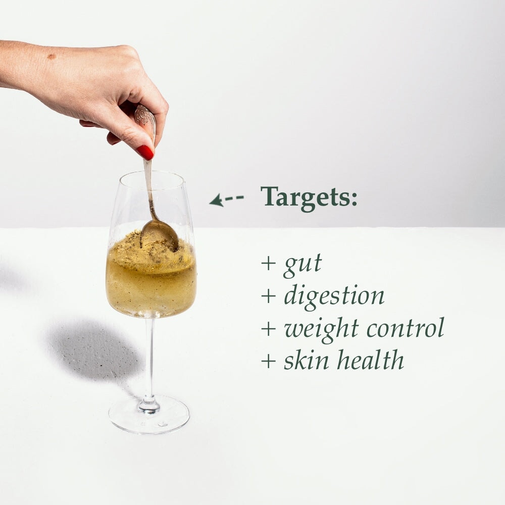 Organic Biota Pulver mit Wasser in Weinglas auf weißem Hintergrund