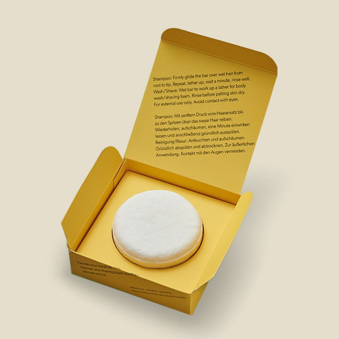 Offene Produktverpackung mit nachhaltigem Shampoo-Bar für Haar und Körper. North Glow
