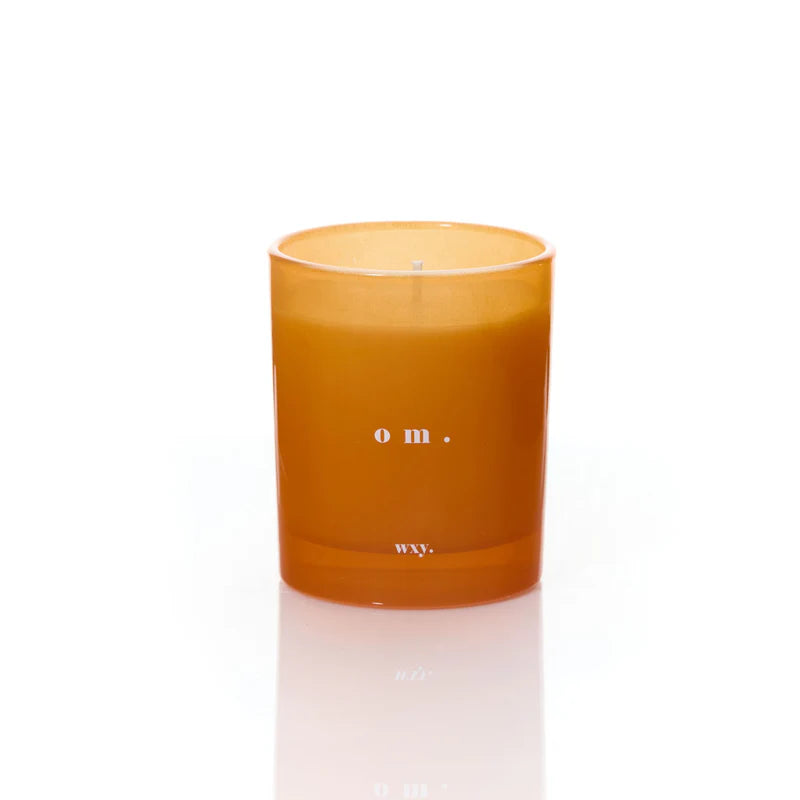 Kerze om von wxy. in orangenem Glas.