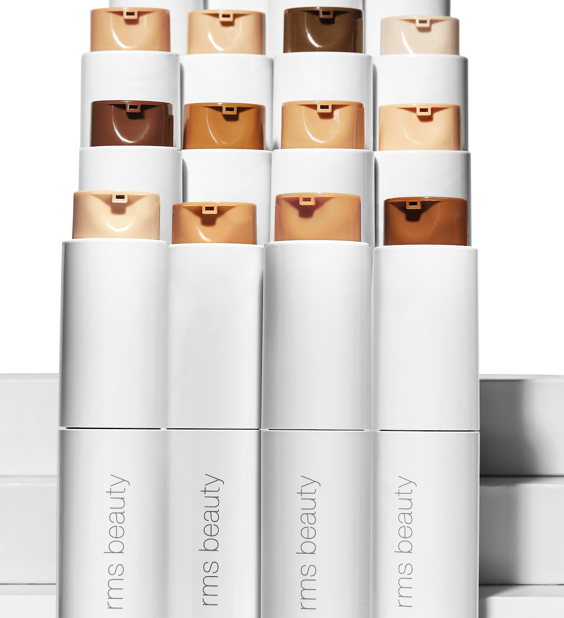 12 Tuben ReEvolve natural liquid finish foundations stehen vor weißem Hintergrund.