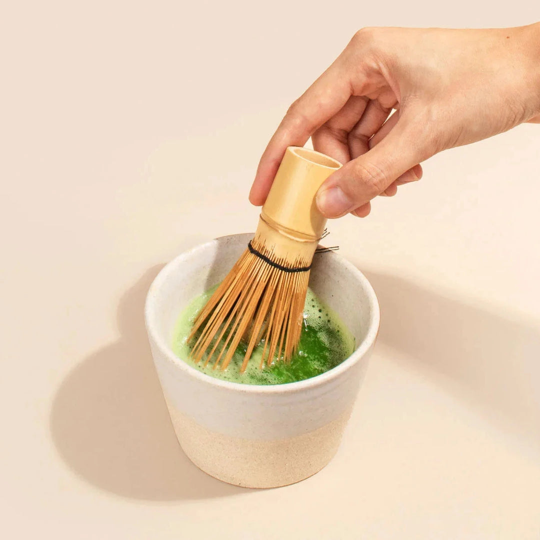 MATCHA & CO Chasen schäumt Matcha in einer traditionellen Schale auf