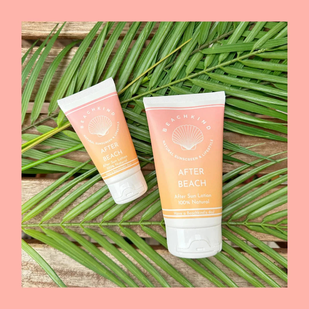 Beachkind After Beach Lotion in two different sizes lying on fern leaves.