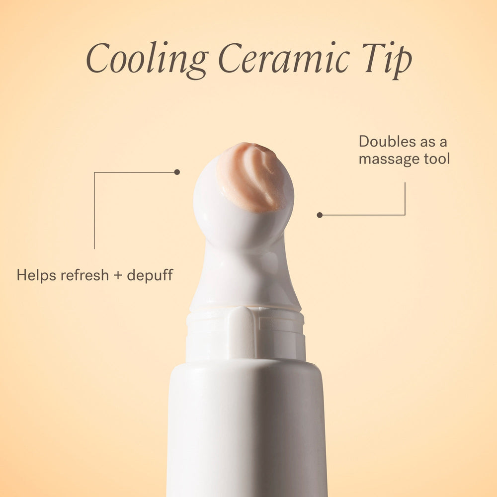 Close-up of the ceramic tip of the ILIA Bright Start Activated Eye Cream Tube with escaping cream against a light background. 