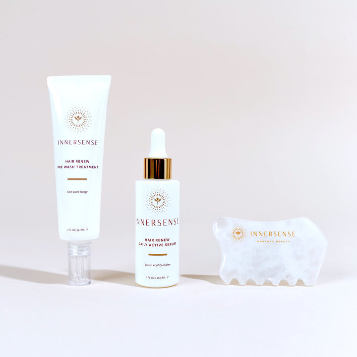 3 products of the Innersense Harmonic Hair Renew Set in front of a light pink background.