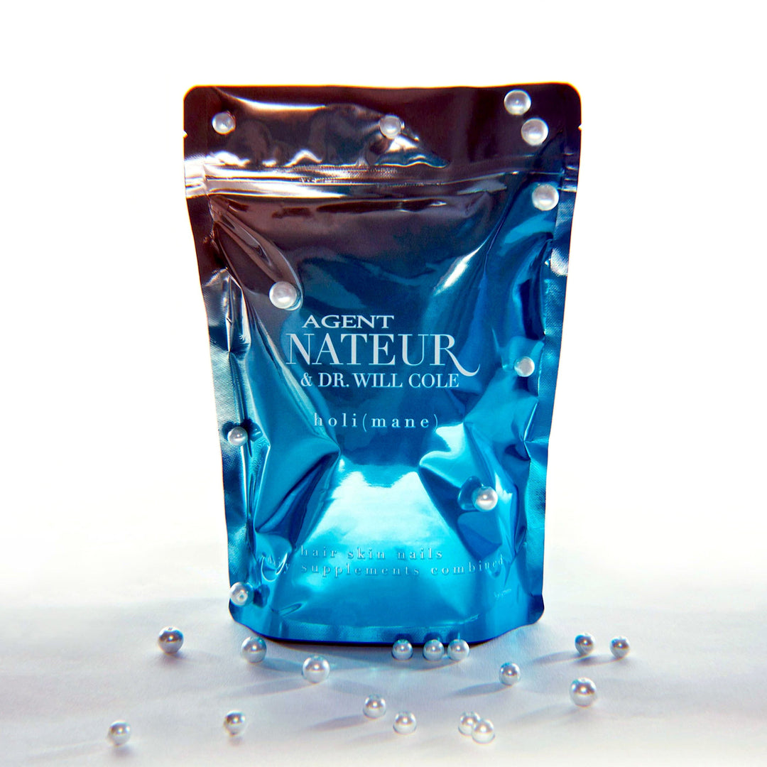  (mane) hair skin nails supplement bag against a white background decorated with pearls. North Glow