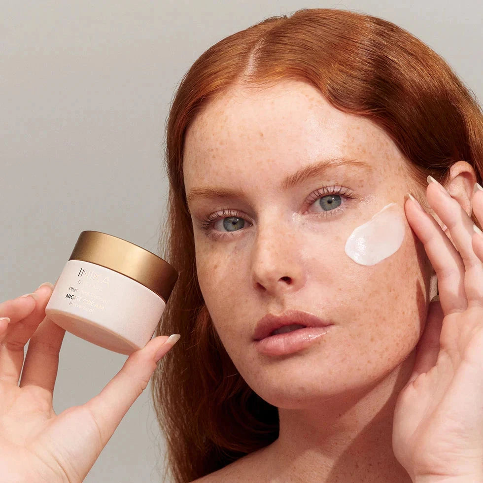 Woman applies INIKA Phytofuse Renew Night Cream to cheek on North Glow