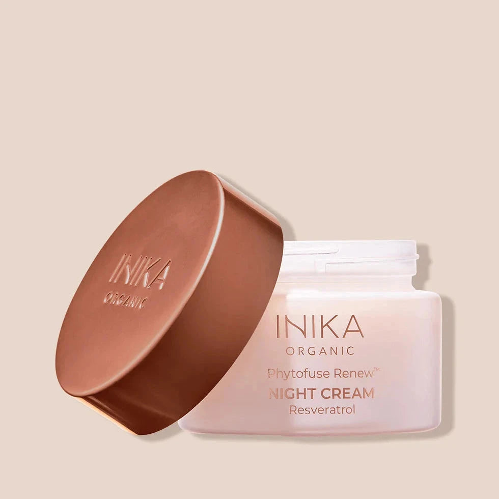 INIKA Phytofuse Renew night cream in pink milky jar with bronze-colored lid on beige background North Glow