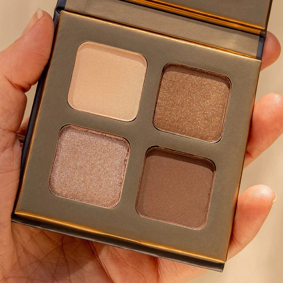 INIKA Organic Quad Eyeshadow Palette (wind) opened and held by one hand. North Glow
