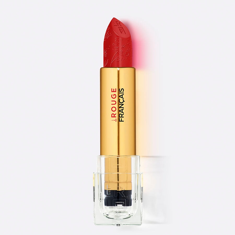 Der Lippenstift Le Rouge Tinctorial No 011 Alizarine steht offen vor weißem Hintergrund. North Glow