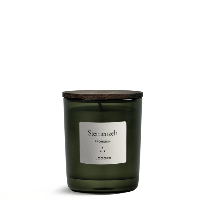Green "Sternenzelt" candle jar from Looops with lid against a white background.