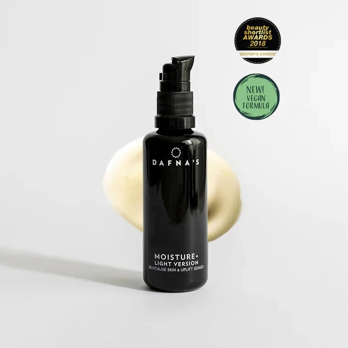 Black pump bottle with white lettering, Dafna's MOISTURE + LIGHT against a light background.