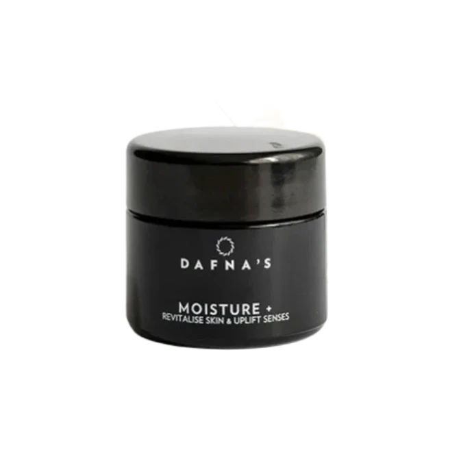Black jar with white lettering, Dafna's MOISTURE + against a white background. North Glow
