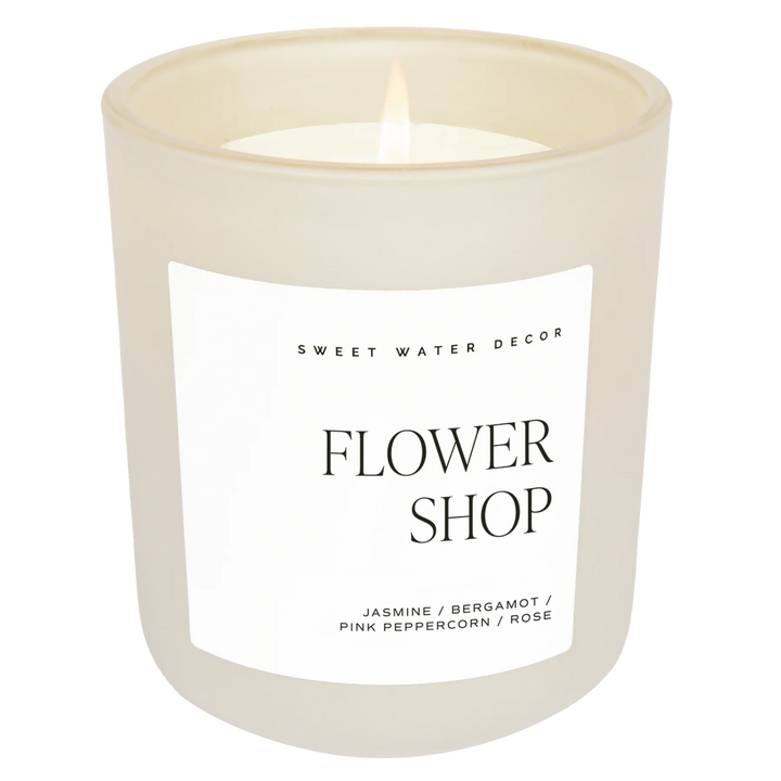 Candle in cream-colored milk glass "FLOWER SHOP" by Sweet Water Decor against a white background