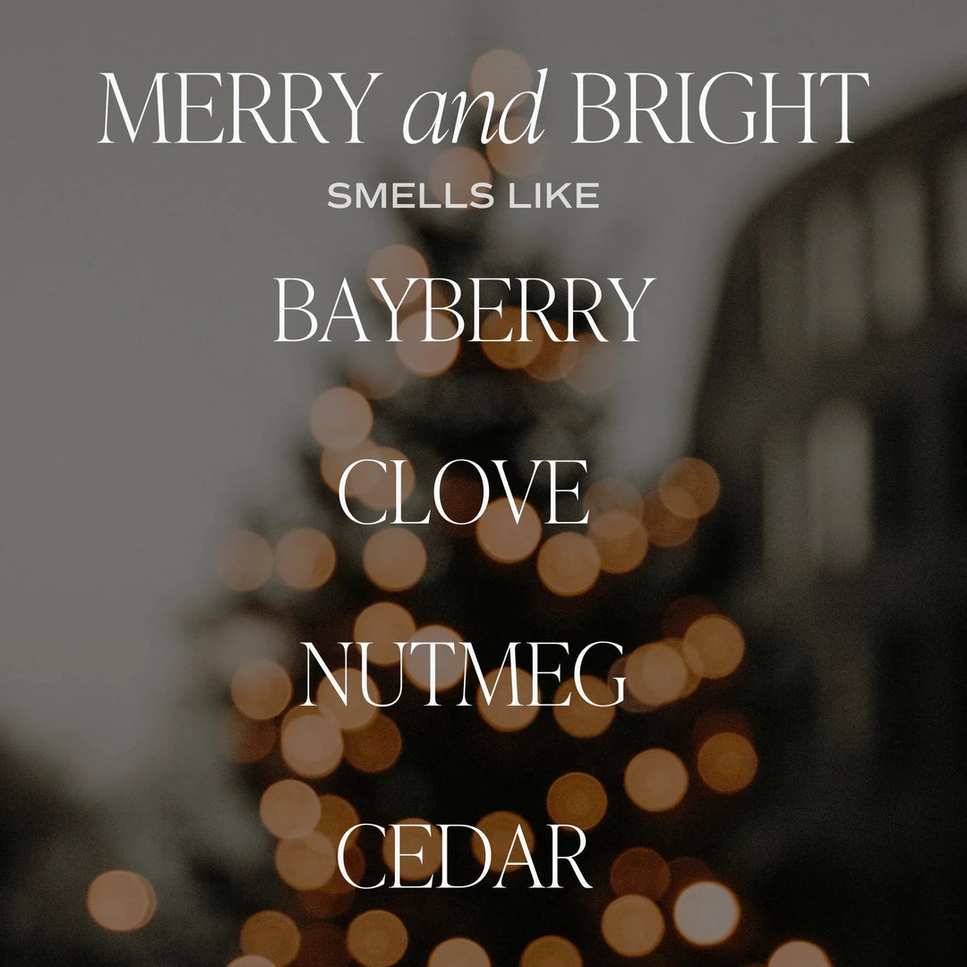 An illuminated Christmas tree in the background, in the foreground the words: MERRY and BRIGHT smells like BAYBERRY, CLOVE, NUTMEG, CEDAR. North Glow