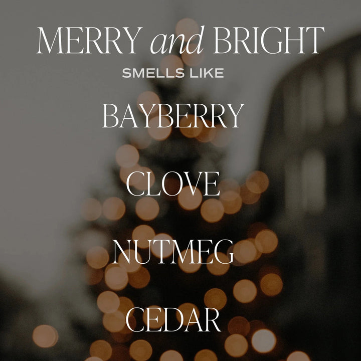An illuminated Christmas tree in the background, the words: MERRY and BRIGHT smells like BAYBERRY, CLOVE, NUTMEG, CEDAR.