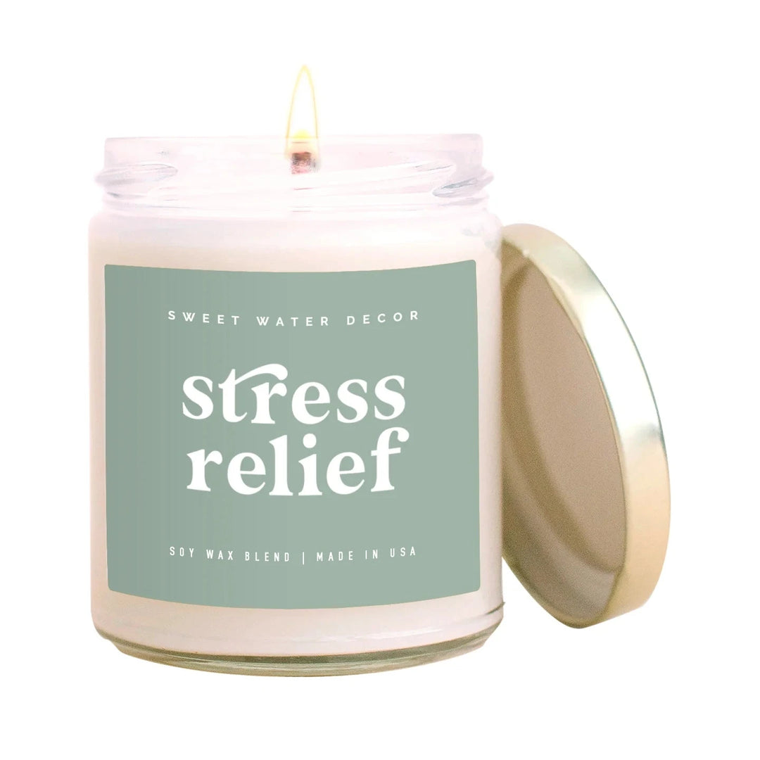 Candle jar with open lid "stress relief" by Sweet Water Decor against a white background.
