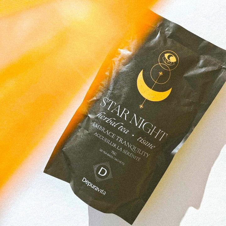 A bird's eye view of the Depuravita Star Night tea pack with light reflections.