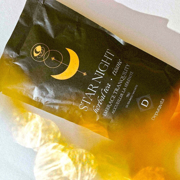 A bird's eye view of the Depuravita Star Night tea pack with light reflections. 