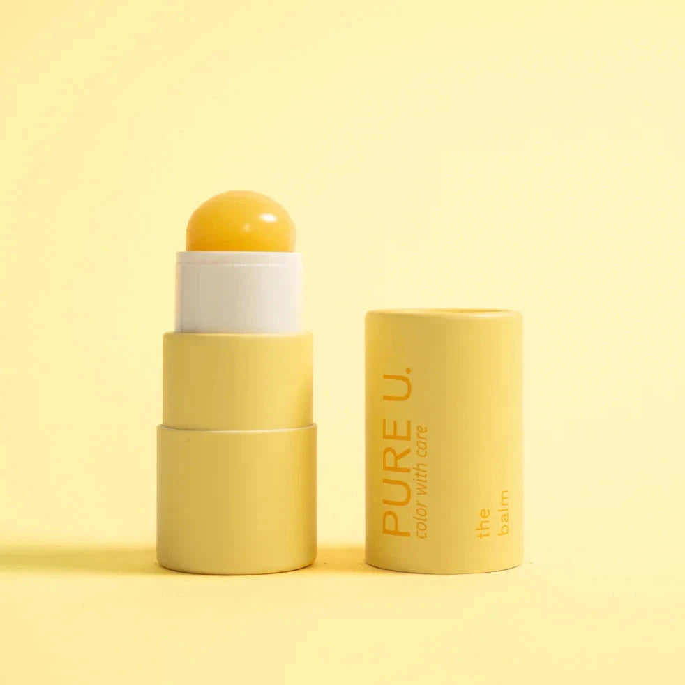 "The Balm" from PURE U. Cosmetics opened against a pale yellow background