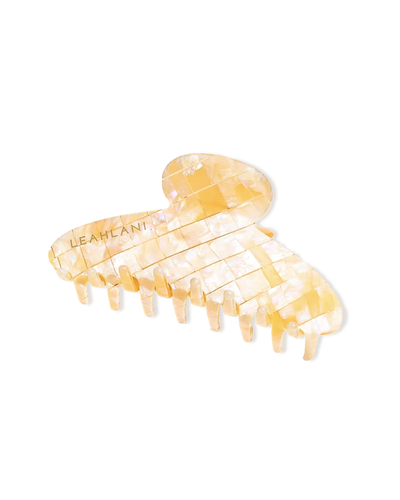Mother-of-pearl-colored hair clip from LEAHLANI against a white background.
