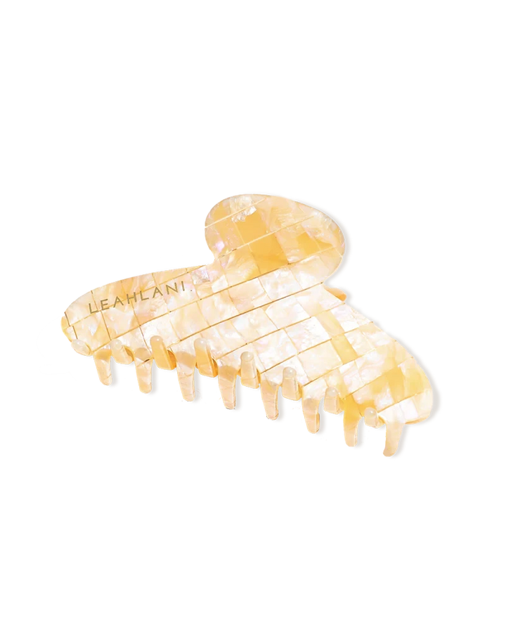 Mother-of-pearl-colored hair clip from LEAHLANI against a white background.