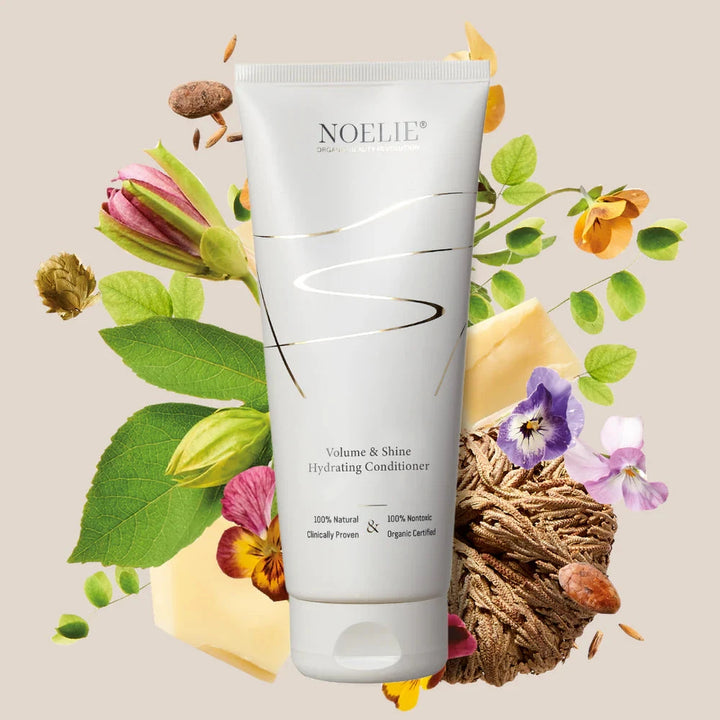 NOELIE Volume & Shine Hydrating Conditioner, im Hintergrund Blumen und Pflanzen.