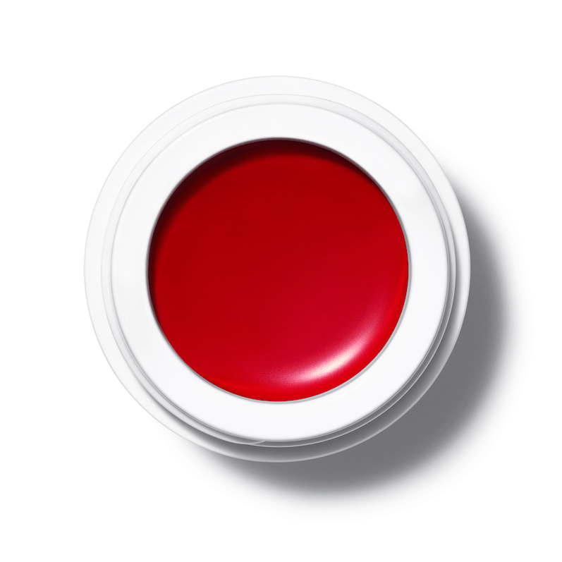 A bird's eye view of an open All Over Color jar of Alizarin on a white background.