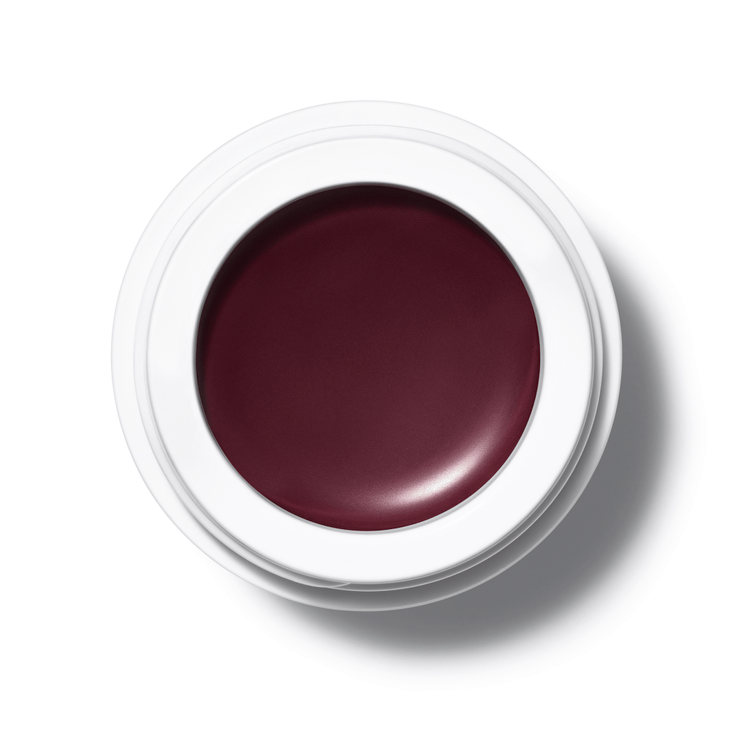 A bird's eye view of an open All Over Color jar of Mangosteen on a white background.