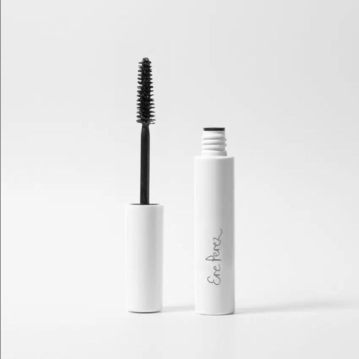 Ere Perez Mascara twisted open, lid upside down with brush facing up, the other half of the container next to it.