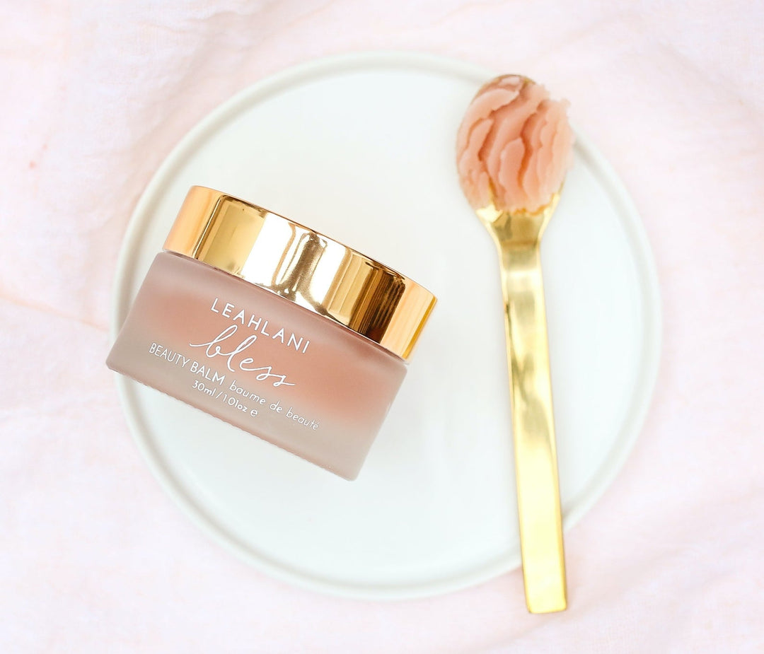 Leahlani Bless Beauty Balm Jar With Gold Lid And Gold Spatula With Blam On Light Plate North Glow