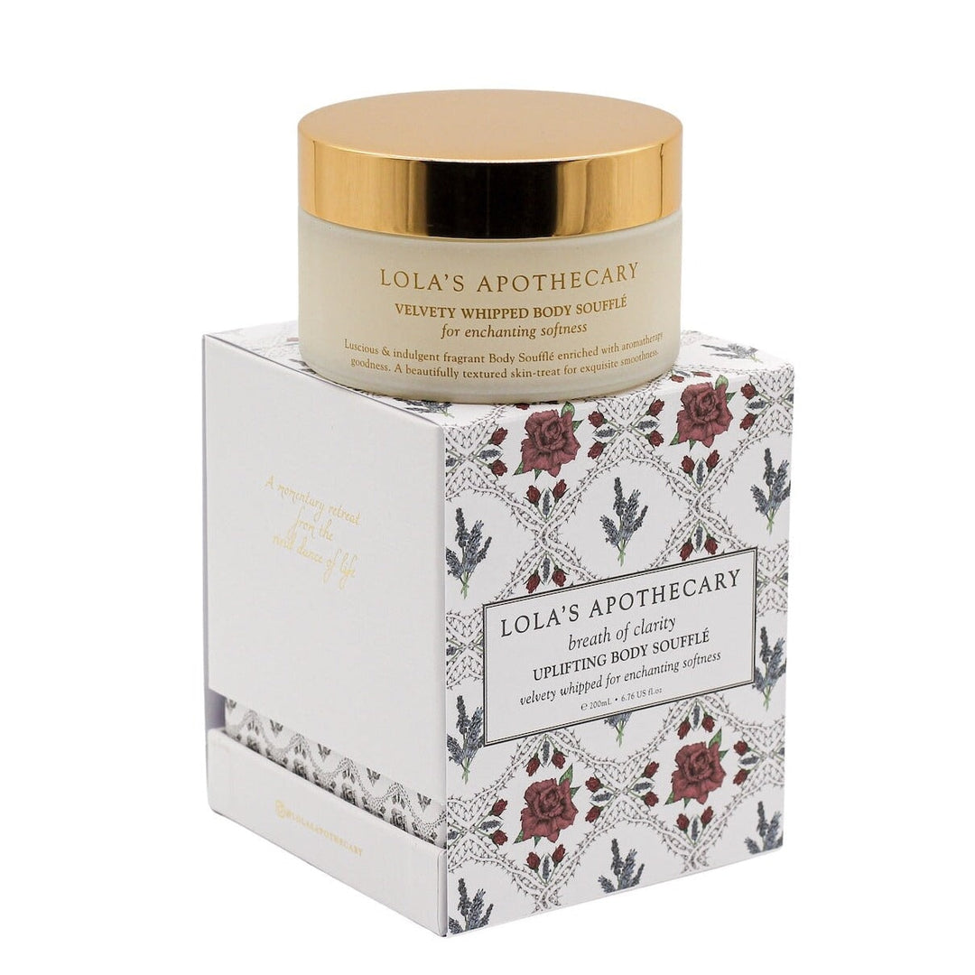 Lola's Breath of Clarity Body Souffle packaging on cardboard against light background