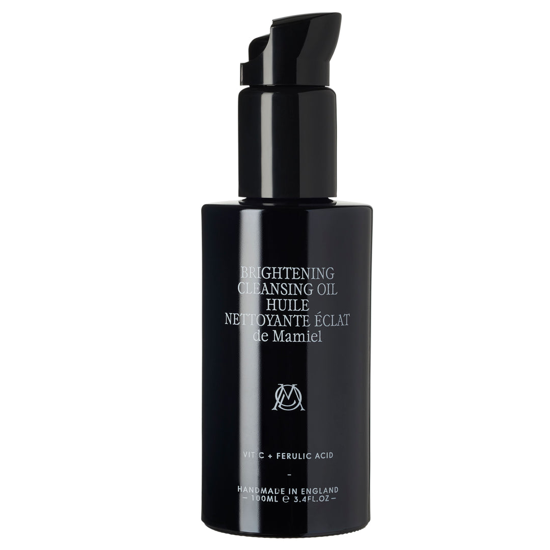 De Mamiel Brightening Cleansing Oil black bottle against a white background North Glow