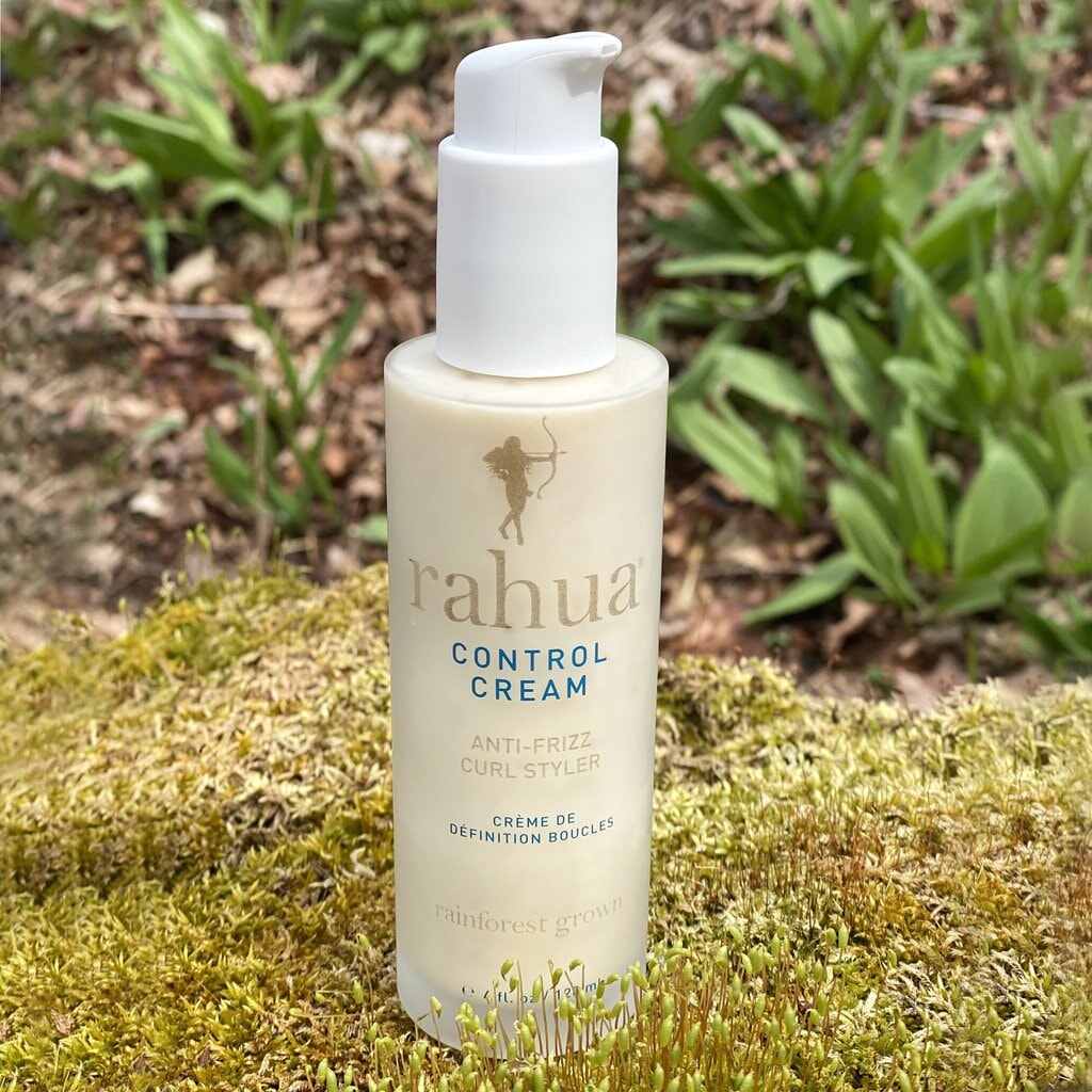 Rahua Control Cream Curl Styler bottle stands on moss in nature. North Glow