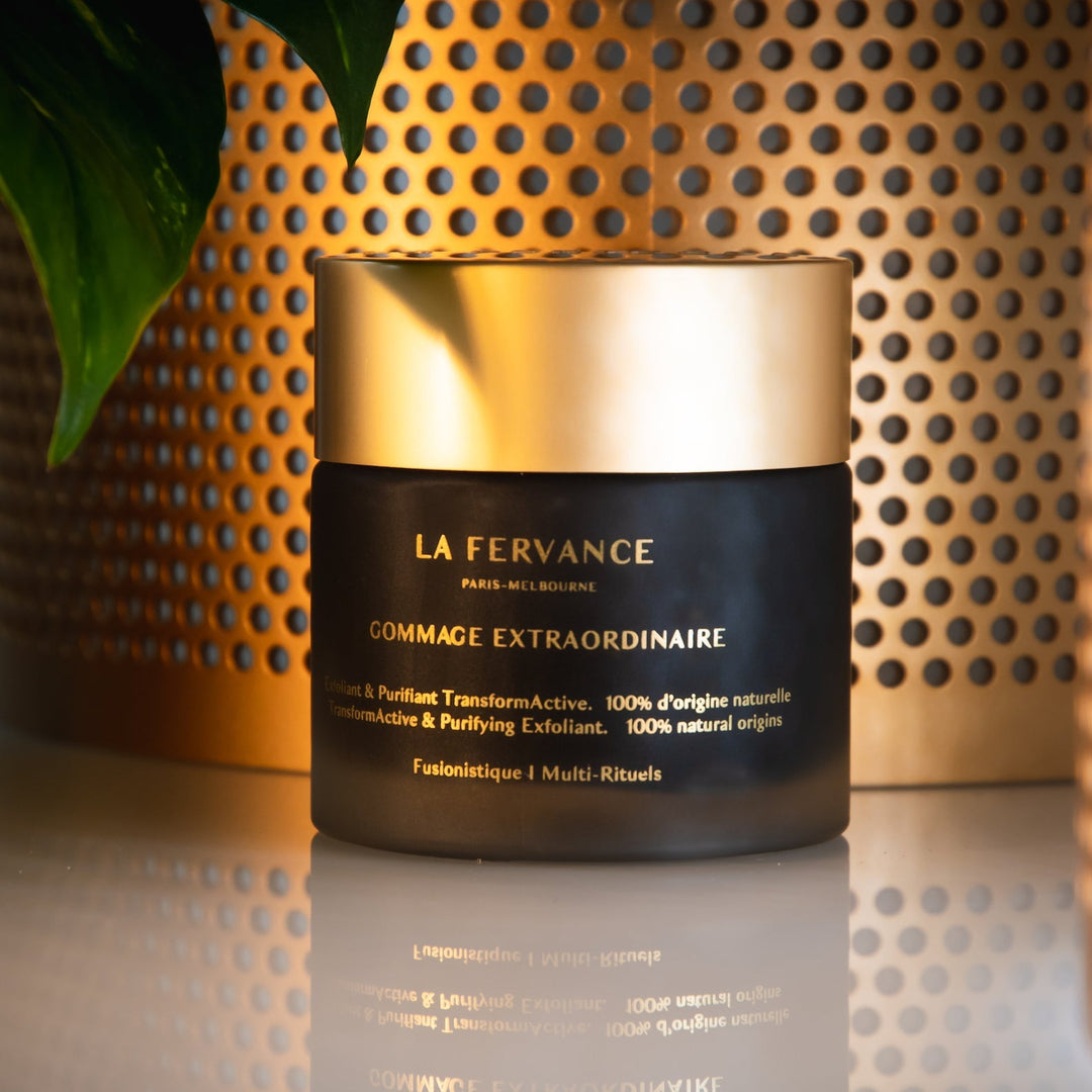 La Fervance Gommage Extraordinaire jar on white table against gold background North Glow