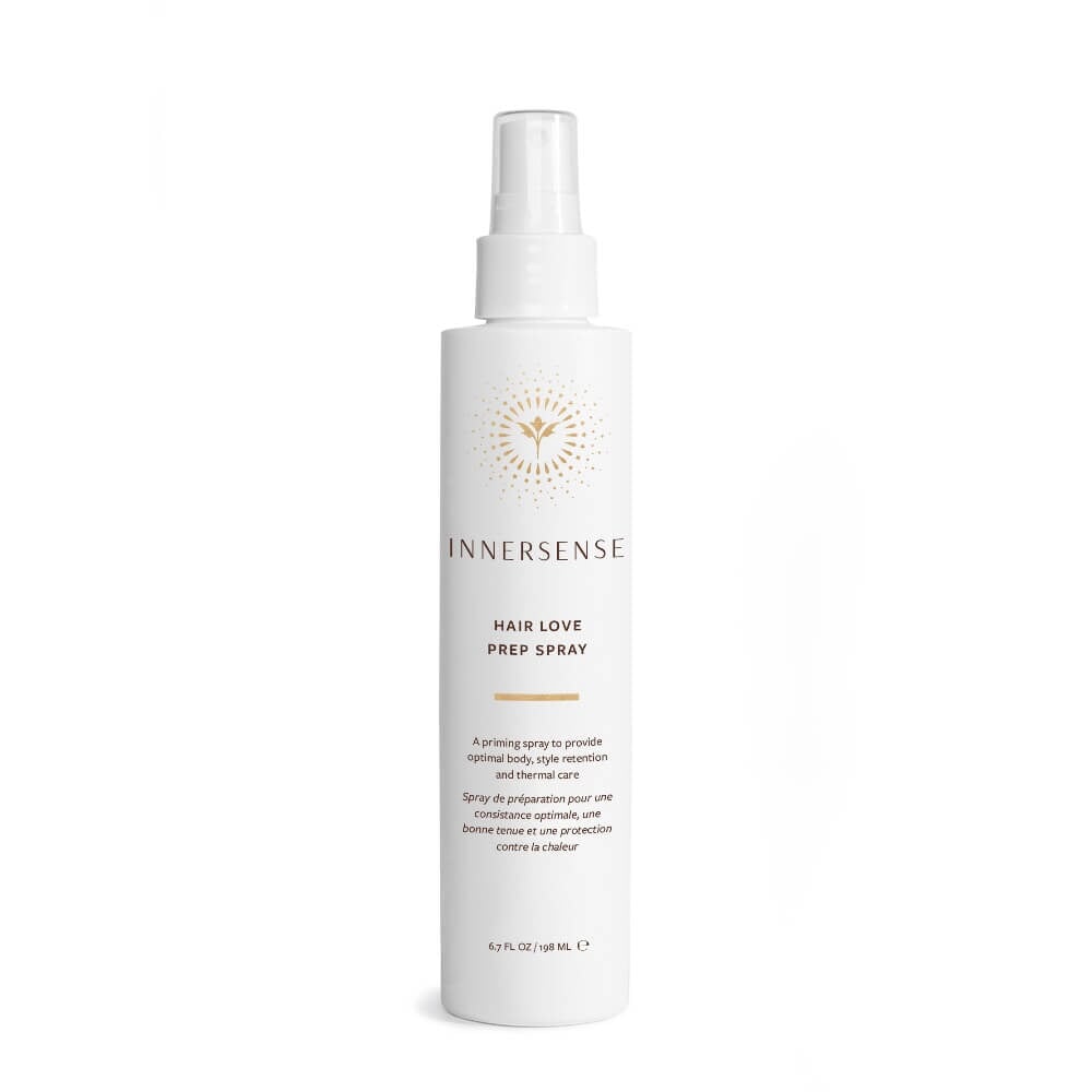White spray bottle Innersense Hair Love Prep Spray stands against a white background.