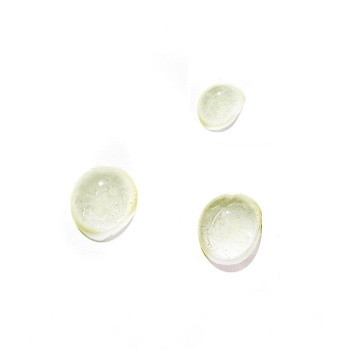 Leahlani Happy Hour Balancing Serum Texture Drops Against White Background
