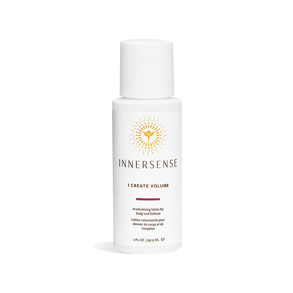 A white travel-size Innersense I Create Volume bottle stands against a white background. North Glow