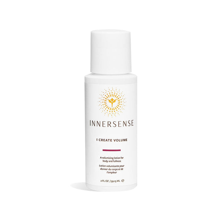 A white Innersense I Create Volume bottle in travel size stands against a white background.