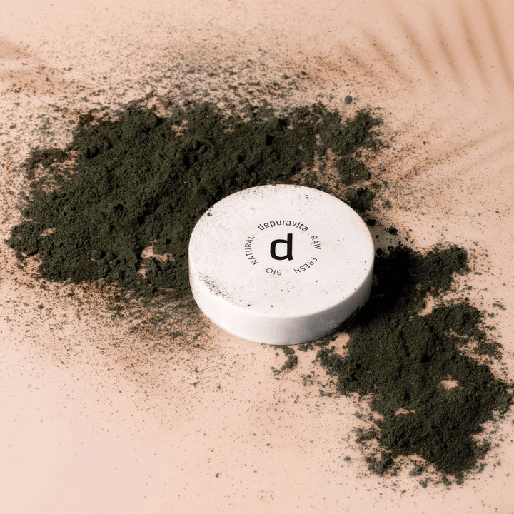 Depuravita Joy Purity jar in black powder on light background